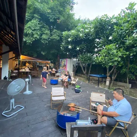 Families cooking on a barbecue beside the outdoor café