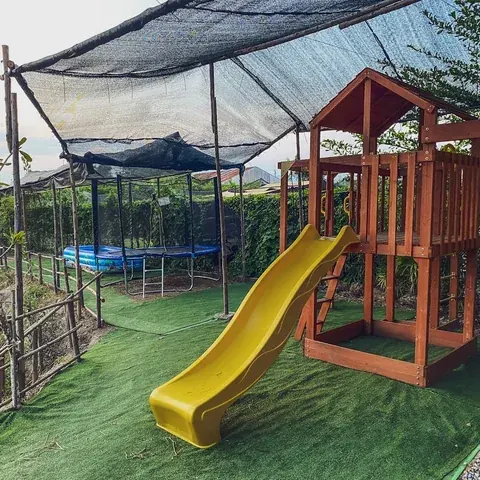 Yellow slide, climbing frame and trampoline at Beaver Club