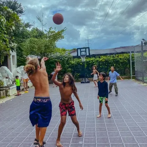 Children playing together on the outdoor basketball court