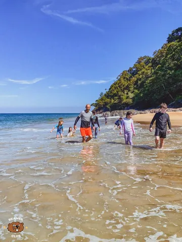 Families walking together in the shallow sea on a previous island outing